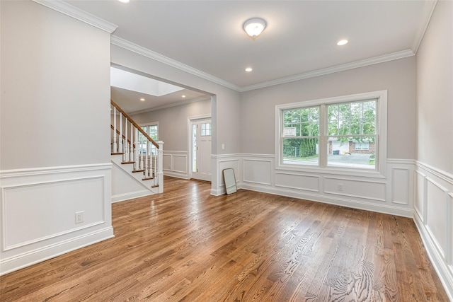 interior space with hardwood / wood-style flooring and ornamental molding