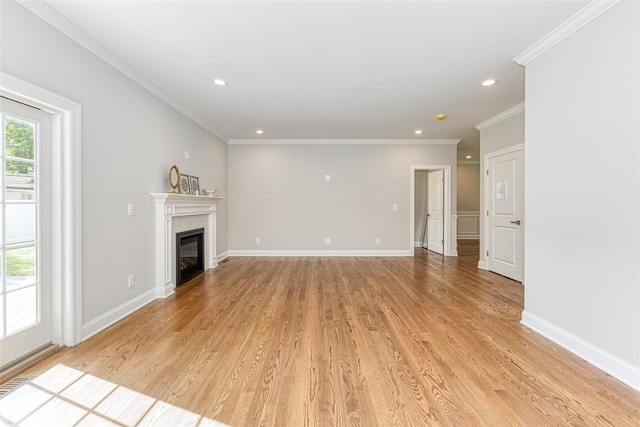 unfurnished living room with light hardwood / wood-style floors and crown molding