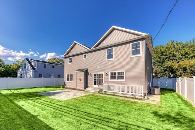 rear view of property with a lawn, central AC, and a patio