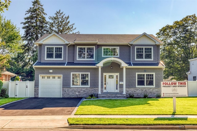 view of front of property with a garage and a front lawn