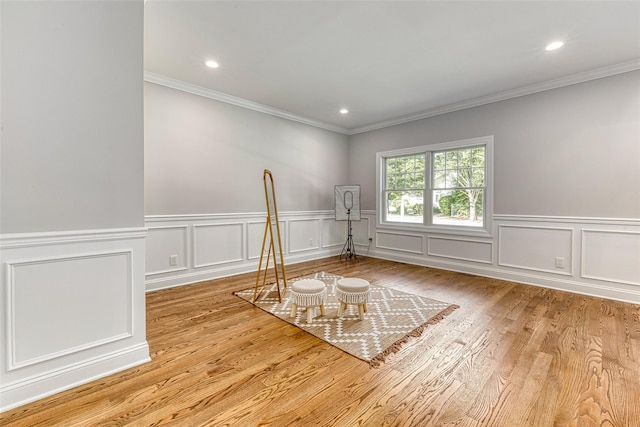 unfurnished room with light wood-type flooring and ornamental molding