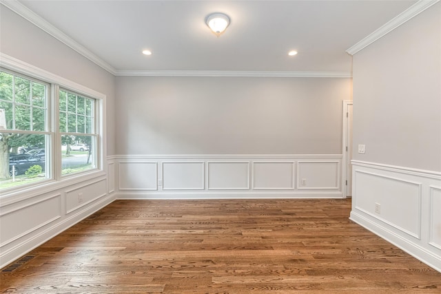 empty room with crown molding and wood-type flooring