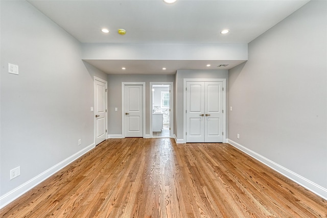 unfurnished room with light wood-type flooring