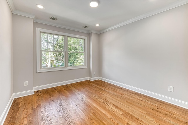 unfurnished room with crown molding and hardwood / wood-style floors