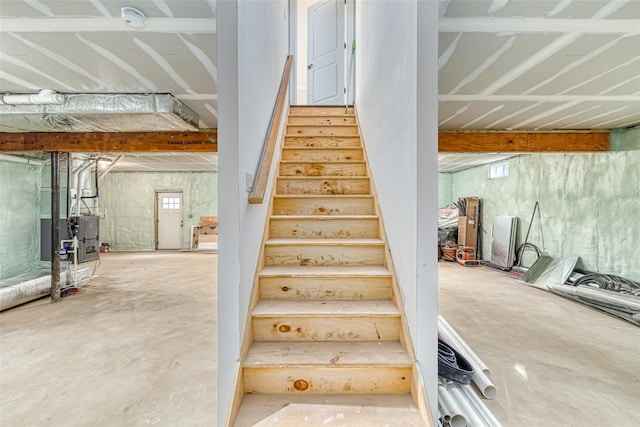 staircase with concrete flooring