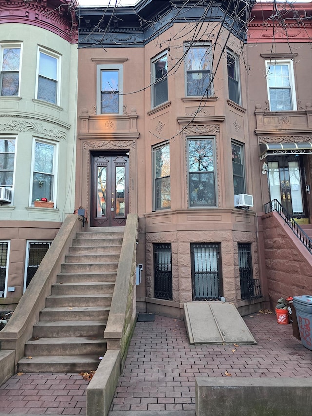 view of exterior entry with french doors and cooling unit