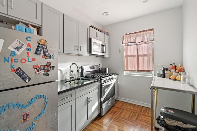 kitchen featuring gray cabinetry, sink, and stainless steel appliances