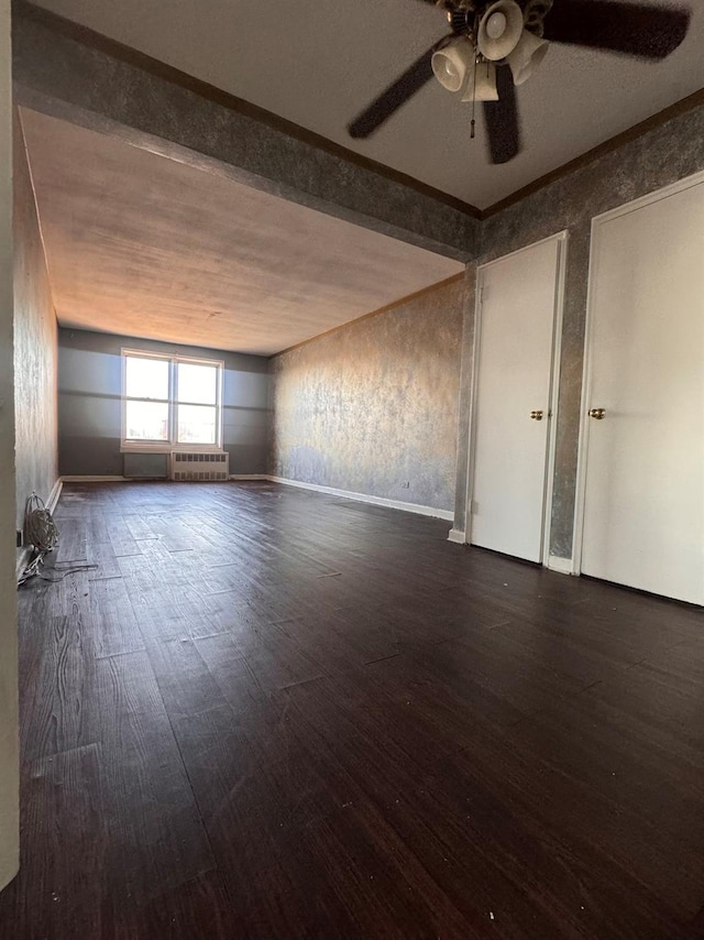 unfurnished room featuring ceiling fan and dark wood-type flooring