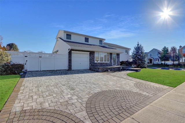 view of property with a garage and a front yard