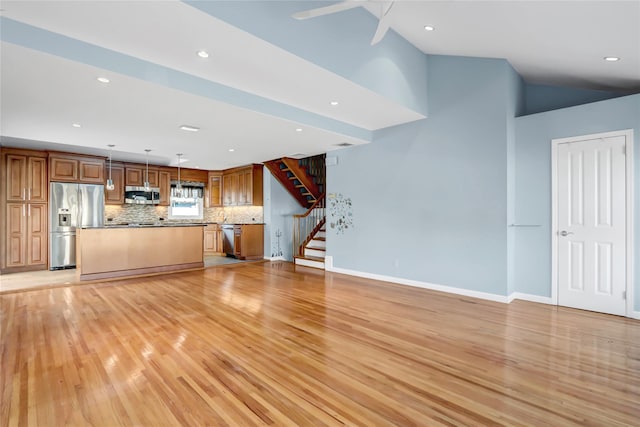 unfurnished living room featuring light hardwood / wood-style floors and lofted ceiling