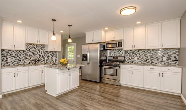 8 Maple Dr, Warwick, NY 10990 - kitchen featuring stainless steel appliances, white cabinets, decorative backsplash, wood finished floors, and recessed lighting