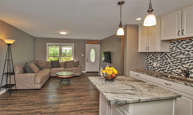 8 Maple Dr, Warwick, NY 10990 - kitchen featuring open floor plan, decorative backsplash, light stone countertops, dark wood-style flooring, and white cabinets