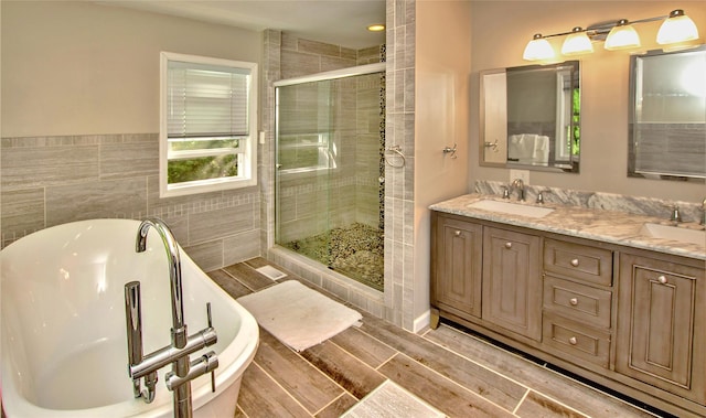 8 Maple Dr, Warwick, NY 10990 - bathroom with a shower stall, a freestanding tub, tile walls, double vanity, and wood finished floors