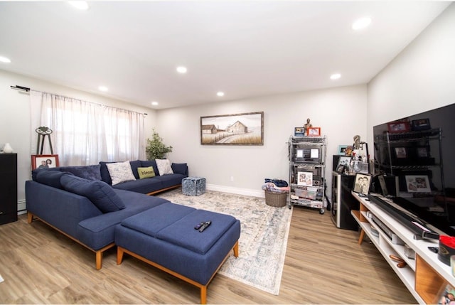 living room with wood-type flooring and a baseboard radiator