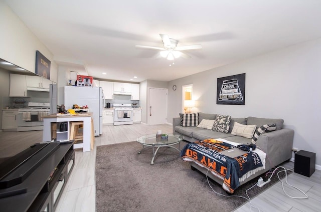 living room featuring ceiling fan and light wood-type flooring