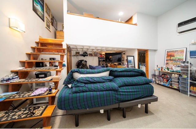 living room featuring a wall mounted air conditioner and a towering ceiling