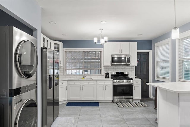 kitchen featuring a wealth of natural light, white cabinetry, and appliances with stainless steel finishes