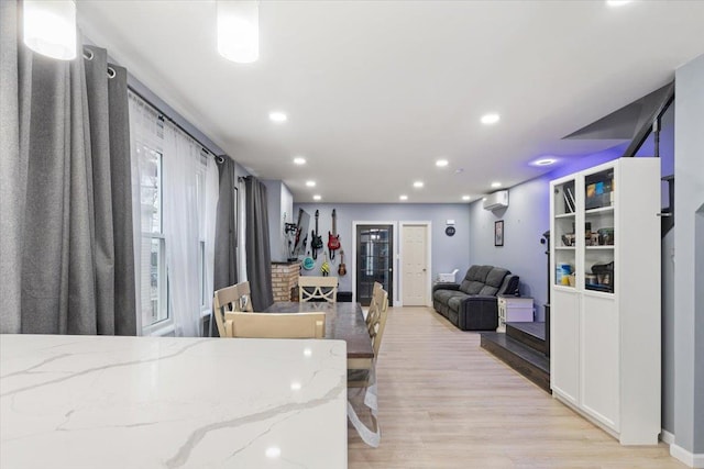 interior space featuring a wall mounted AC and light wood-type flooring