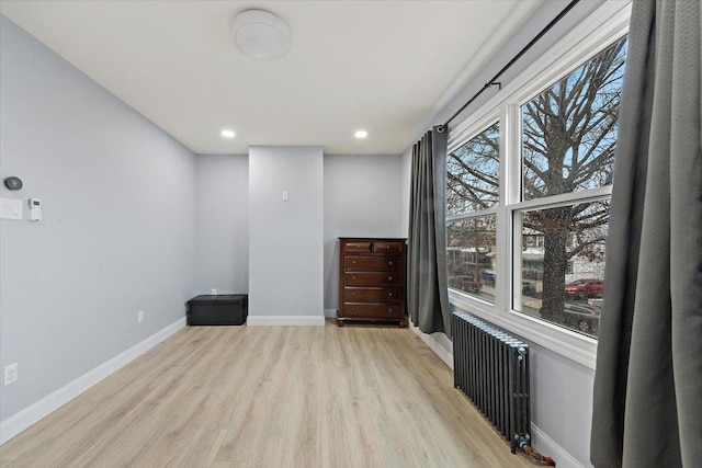 empty room featuring light hardwood / wood-style floors and radiator