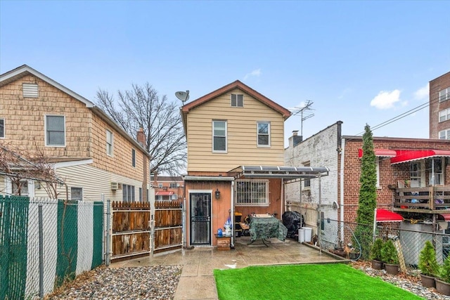 rear view of property with a lawn