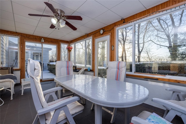 sunroom / solarium with a paneled ceiling and ceiling fan