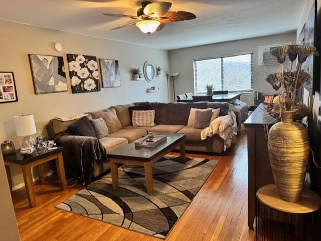 living room with hardwood / wood-style flooring and ceiling fan