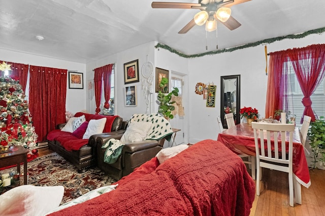 living room with light wood-type flooring and ceiling fan