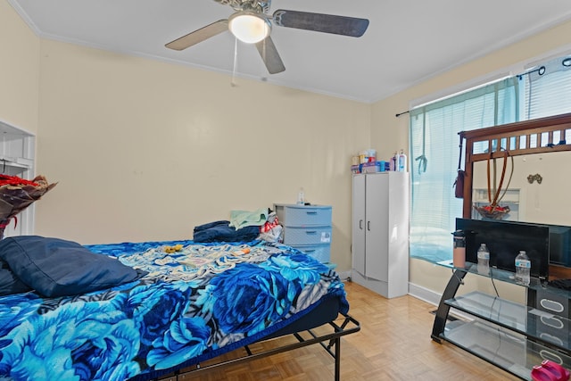 bedroom featuring ceiling fan, crown molding, and light parquet flooring