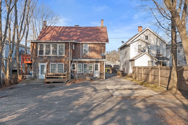 rear view of property featuring a wooden deck