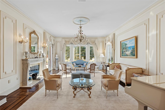 living area featuring a chandelier, ornamental molding, and parquet flooring