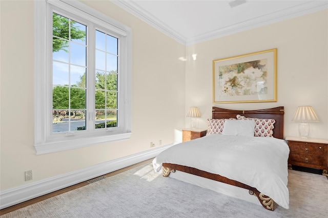 bedroom with wood-type flooring, ornamental molding, and multiple windows