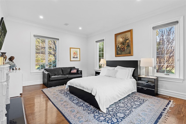 bedroom featuring crown molding and dark wood-type flooring