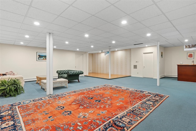 interior space with carpet flooring, a paneled ceiling, and baseboard heating