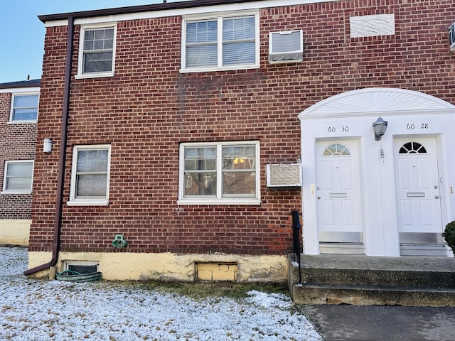 view of snow covered property entrance