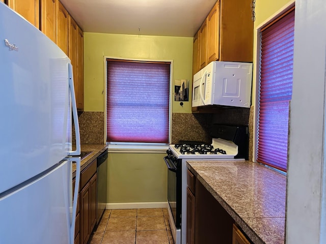 kitchen with light tile patterned flooring and white appliances