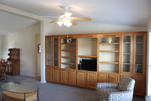 living room featuring ceiling fan, dark carpet, and lofted ceiling