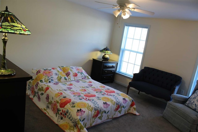 carpeted bedroom featuring multiple windows and ceiling fan