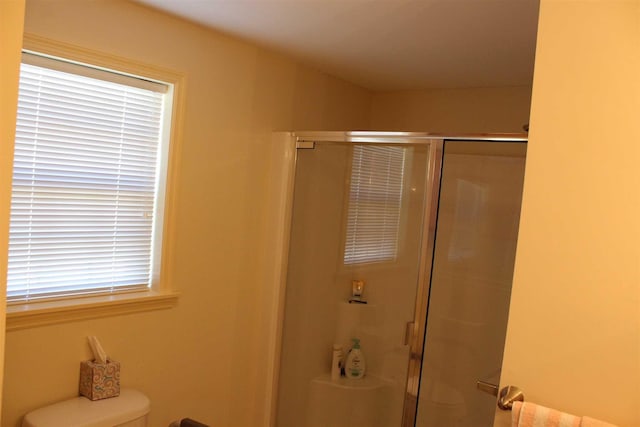 bathroom with toilet and walk in shower