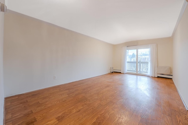 empty room featuring a baseboard radiator, crown molding, and light hardwood / wood-style flooring