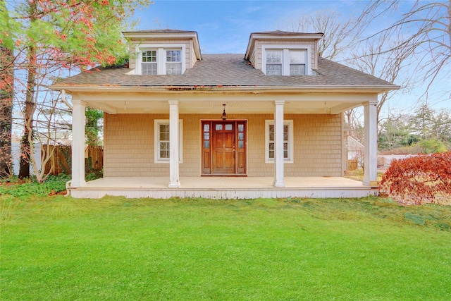 back of property with covered porch and a yard