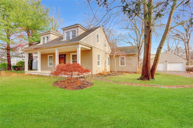 view of front facade with an outdoor structure, covered porch, a front yard, and a garage