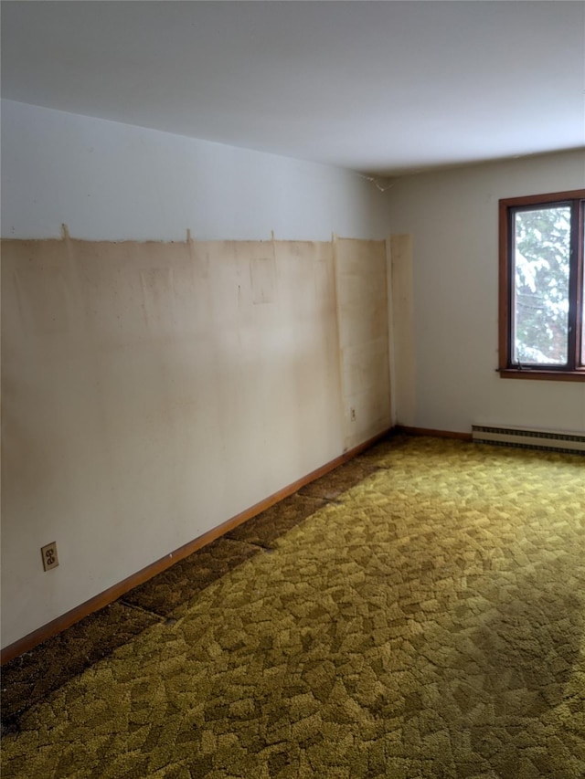 carpeted spare room with baseboard heating