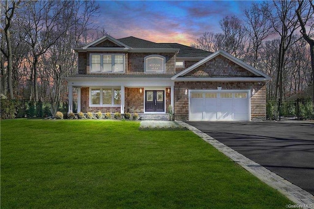 view of front of house featuring a front yard, a garage, and driveway