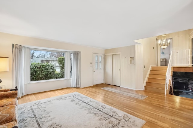 unfurnished living room with hardwood / wood-style floors and an inviting chandelier