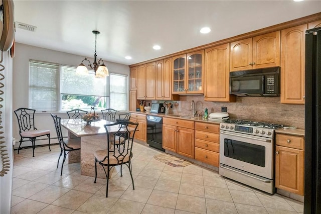 kitchen with an inviting chandelier, black appliances, sink, decorative light fixtures, and light tile patterned flooring