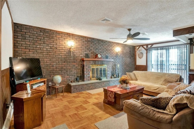 living room with a textured ceiling, brick wall, and a brick fireplace