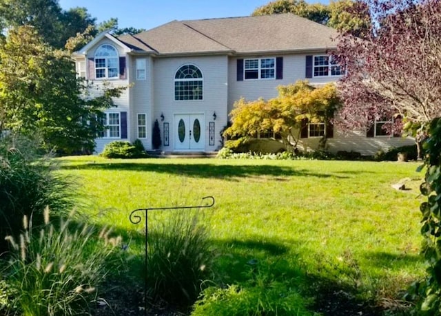 colonial inspired home with a front yard