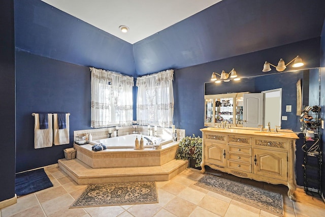 bathroom featuring tile patterned floors, vanity, and a relaxing tiled tub