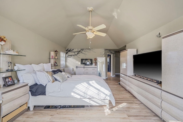 bedroom featuring light wood-type flooring, ceiling fan, and lofted ceiling