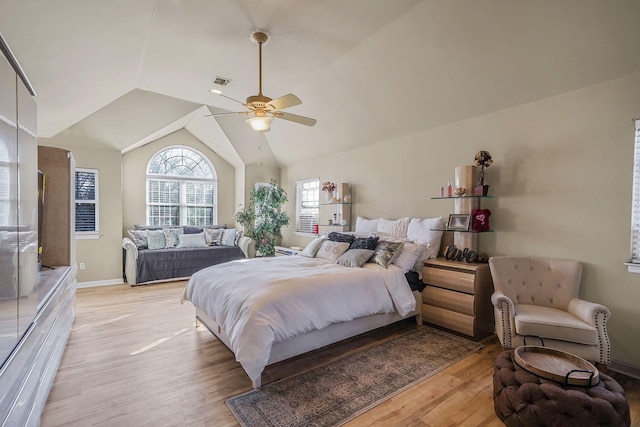 bedroom featuring ceiling fan, light hardwood / wood-style flooring, and lofted ceiling